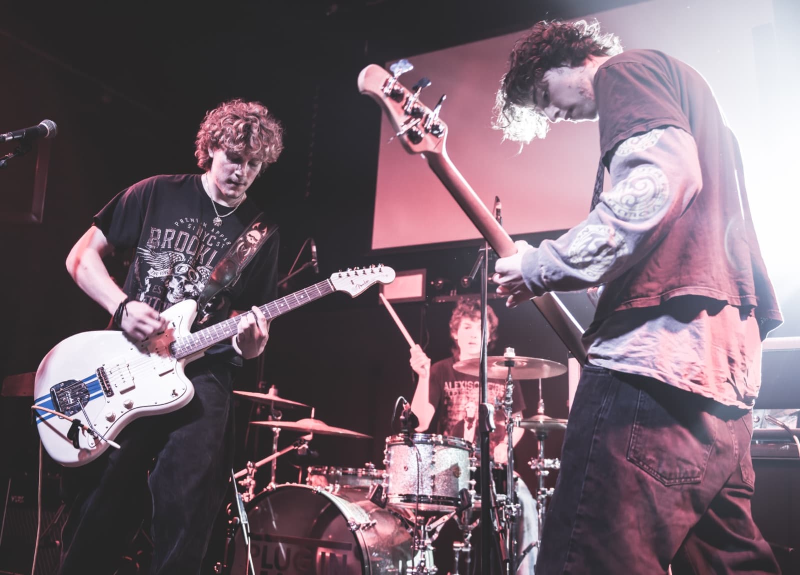 Two Aphid band members performing together at The Brickyard