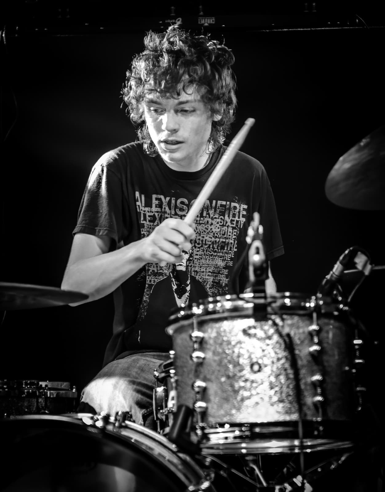 Aphid's drummer performing in black and white