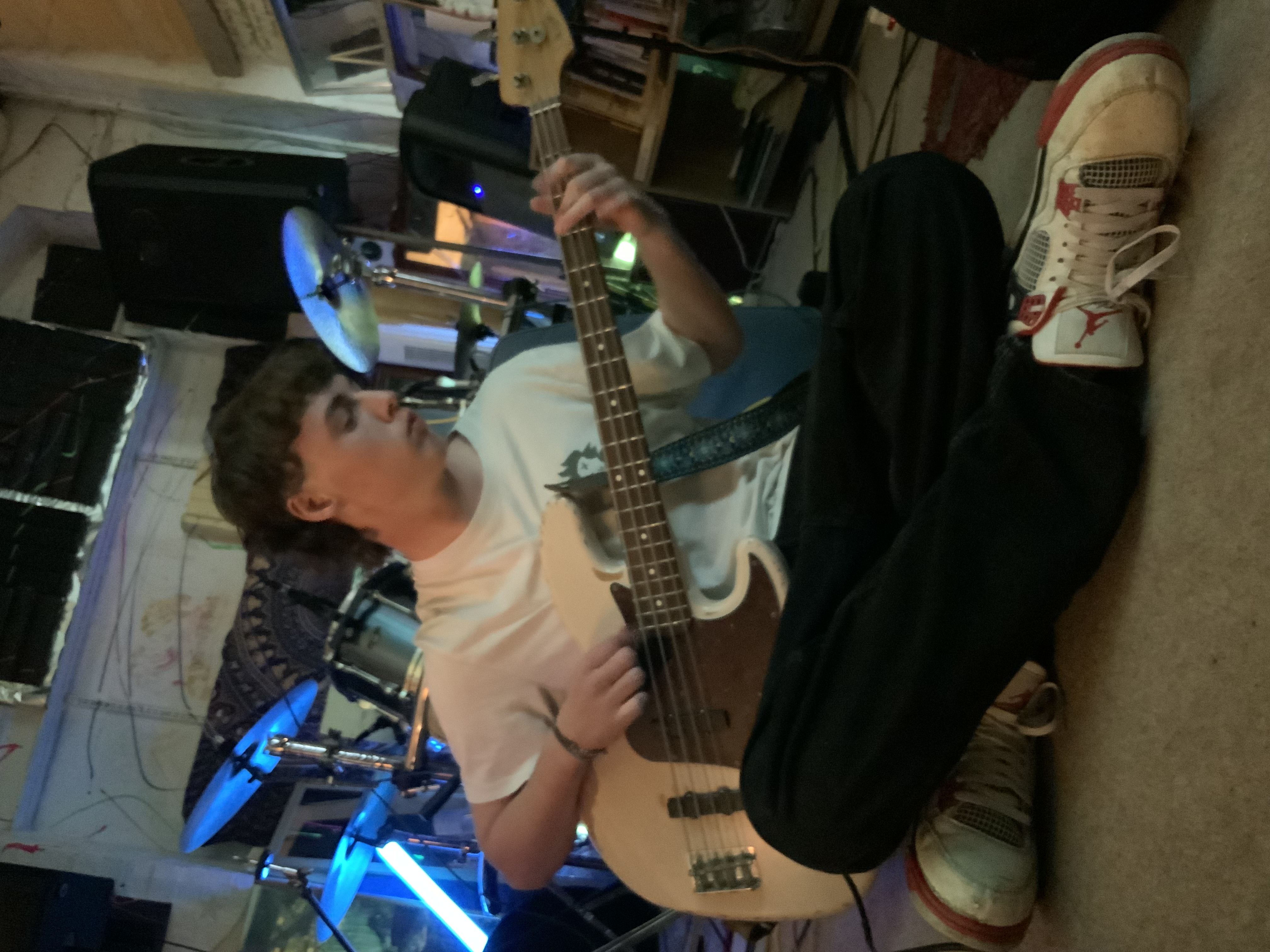 Dylan from Aphid sitting with his bass
